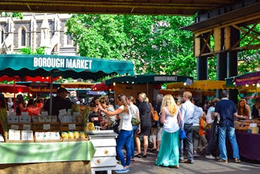 Lively scene at Borough Market in London, filled with people shopping and enjoying the atmosphere.