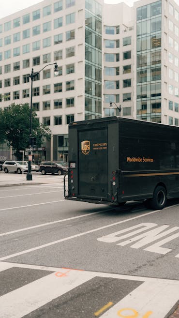 UPS truck navigating city streets in Washington DC, showcasing urban transportation.